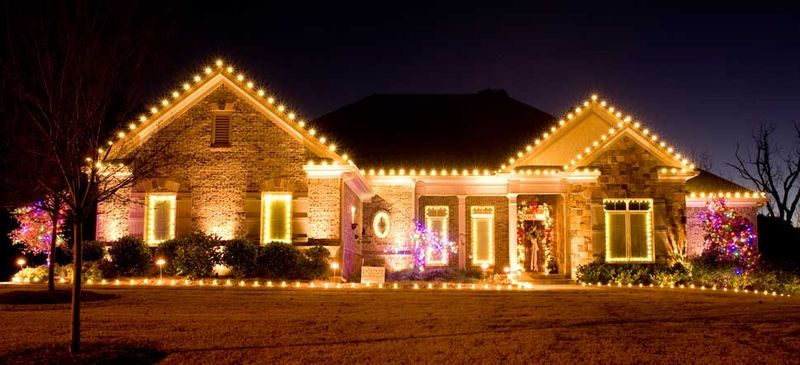 Front porch wrapped in holiday lighting