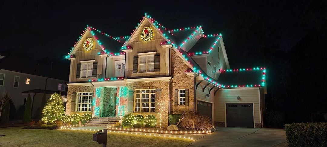 Home outlined in warm white Christmas lights