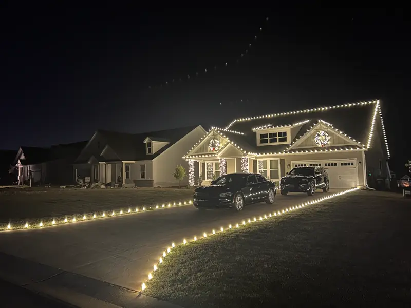 Warm white roofline and driveway lining on a two-car-garage home