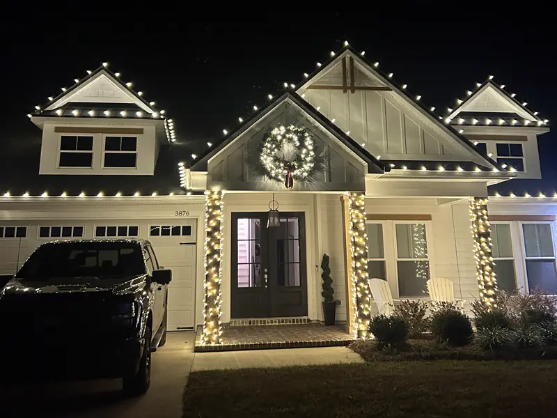 Craftsman home with warm white roofline, wreath and wrapped columns